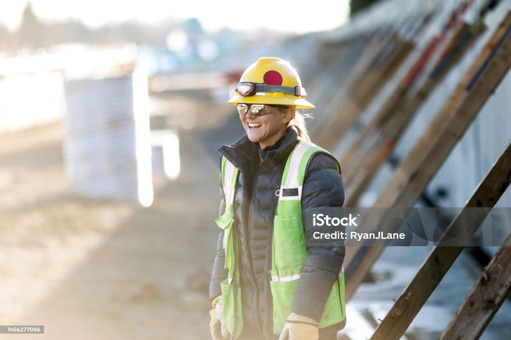 Woman Working In Construction Industry A female Caucasian laborer works on a large scale light-rail project in Washington state.  A well paying trade job for a needed skillset. Construction Worker Stock Photo