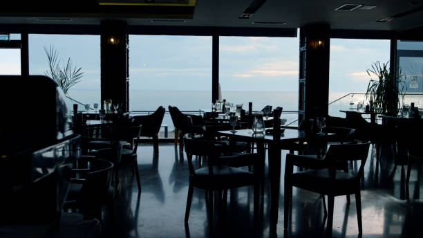 istock Spacious panoramic restaurant interior in evening dusk. Business lunch concept 1456279352