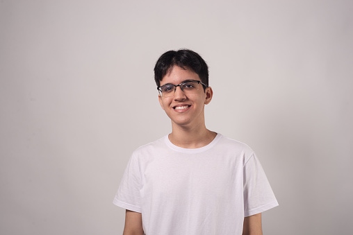 Studio portrait of male teenager on plain background