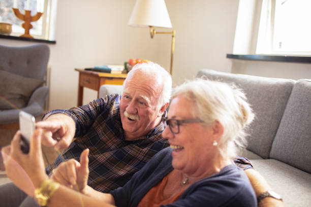 istock Senior couple using a phone at home 1456288332