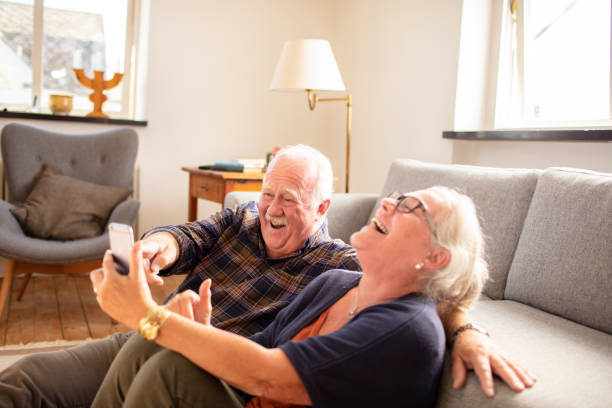 istock Senior couple using a phone at home 1456288410