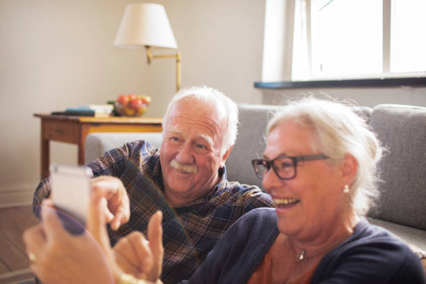istock Senior couple using a phone at home 1456288417