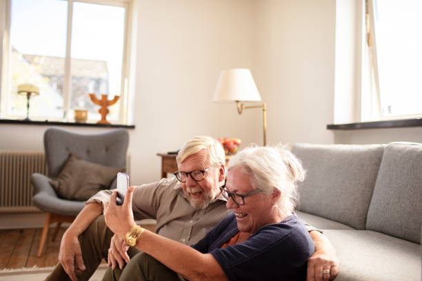 istock Senior couple using a phone at home 1456288441
