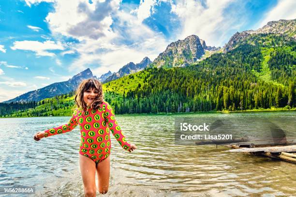 Joyful Child Plays On The Banks Of Scenic String Lake In Grand Teton In Summer Stock Photo - Download Image Now