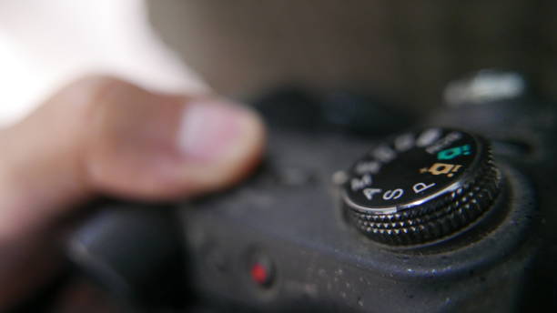 istock Person checking the settings of a digital camera 1456291408
