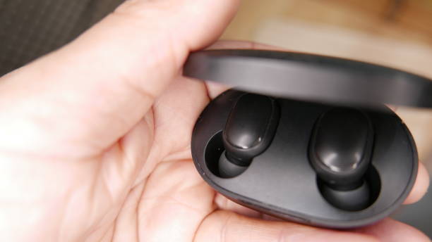 istock Person charging bluetooth earphones 1456292630