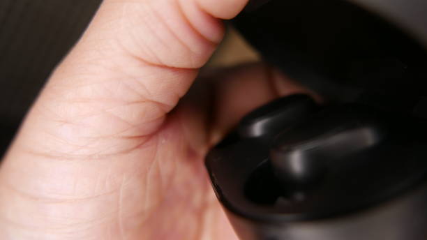 istock Technology: person charging Bluetooth earphones 1456292662