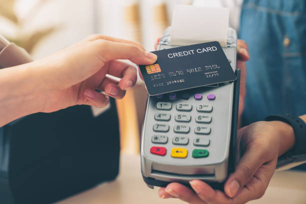 istock Customer using credit card for payment by NFC technology on card reader machine to owner at restaurant. 1456293278