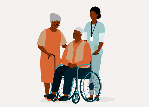 Black Senior Wife With Her Disabled Senior Husband In Wheelchair Is Being Taken Care By A Female Nurse. Isolated On Color Background.