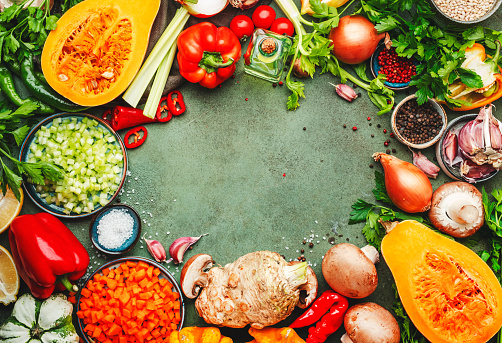 Food background. Vegetables, mushrooms, roots, spices - ingredients for vegan cooking. Healthy eating, diet, comfort slow food. concept. Rustic table, frame border with copy space, top view