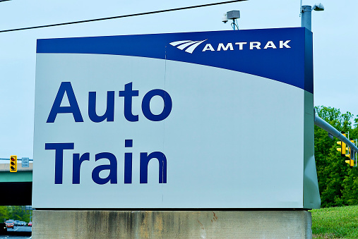 Lorton, Virginia, USA - May 1, 2022: A large metal sign welcomes passengers at the entrance to the Lorton Amtrak Auto Train station.