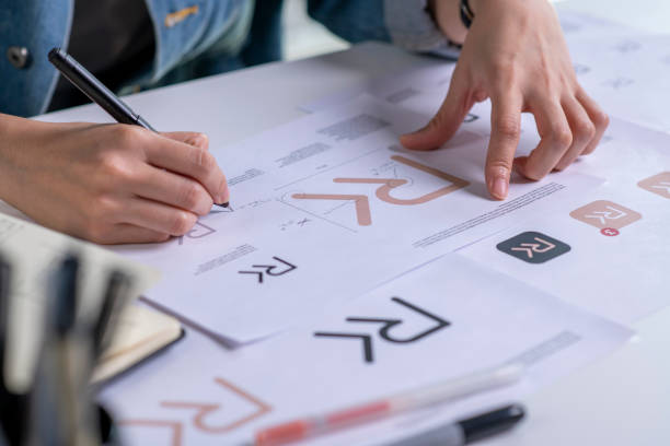 Close up drawing sketches logo design Graphic designer drawing sketches logo design. The concept of a new brand. Professional creative occupation with idea. design professional stock pictures, royalty-free photos & images