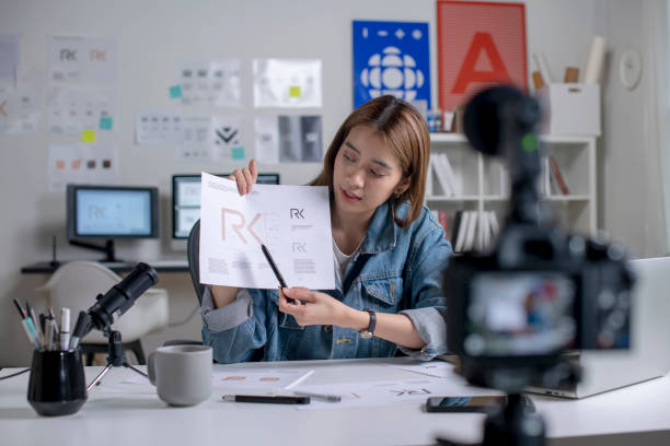 istock Young Asian female graphic designer recording video content for online lesson. 1456302013