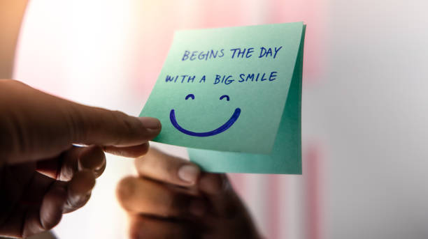 Beginnings, Start and Mental Health Concept. Note on the Mirror with a Big Smiling Face Cartoon. Remind and Practice to Start the Day with a Positive Mind stock photo