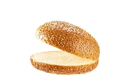 Open and empty sesame seed hamburger bun isolated on white background. Fresh tasty burger bread isolated.