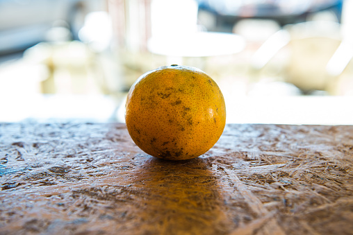 A orange on the wooden table, Thailand