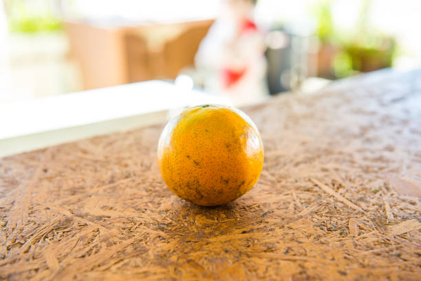 A orange on the wooden table, Thailand