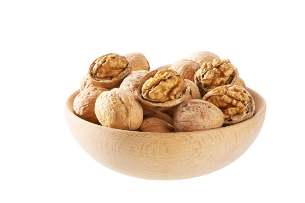 istock Walnuts in wooden bowl  isolated on white background. 1456308280