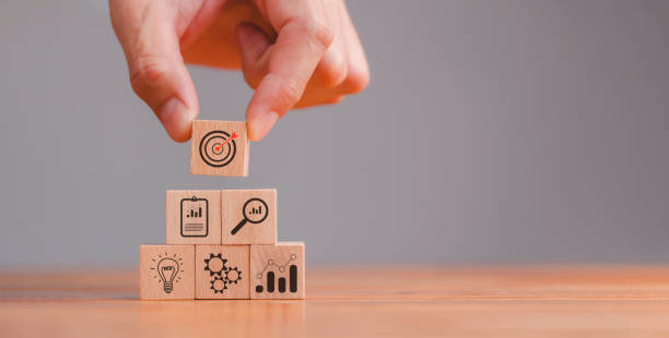istock Action plan, Goal and target, business strategy, hand stack woods block step on table with icon about business strategy and Action plan. business development concept. copy space. 1456310640