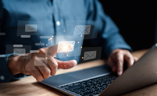 Businessman sending email by laptop computer  to customer, business contact and communication, email icon, email marketing concept, send e-mail or newsletter, online working internet network.