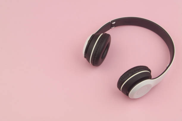 istock Wireless headphones on pink background 1456315364