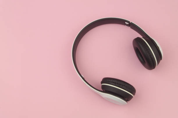istock Wireless headphones on pink background 1456315370