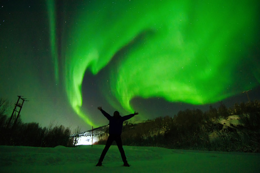 Aurora borealis and silhouette of man in Lofoten, Norway