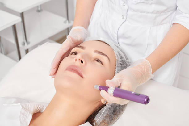 Beautician makes mesotherapy injection for rejuvenation woman face, procedure in beauty salon stock photo