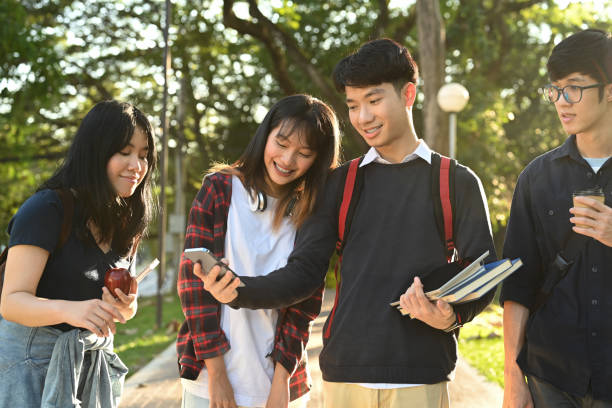 istock Diverse young college friends talking to etch other while walking after classes in university campus outdoors. 1456317499