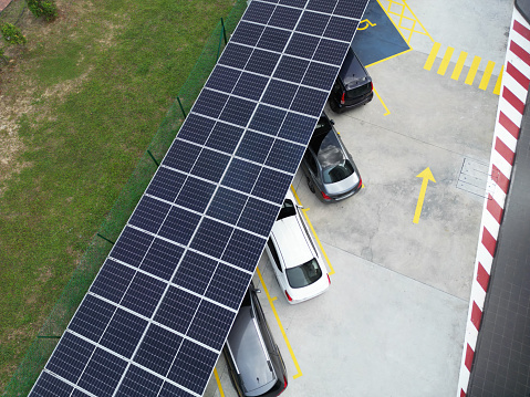 Aerial View of Shopping Center with Solar Panels and Parking Lot .