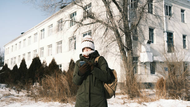 istock Frozen female tourist is looking for the direction using her smart phone 1456317998