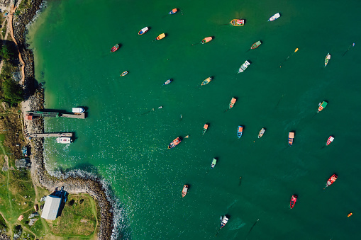 Coastline with piers and boats in Brazil. Aerial view of Ponta das Campanhas in Florianopolis