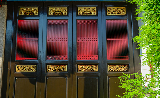 Oriental wooden door of Chinese temple in George Town, Penang, Malaysia.