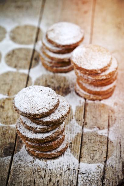 istock Fresh oat cookies stacks with sugar powder on rustic wooden table. 1456320662