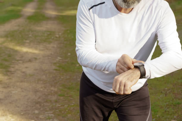 istock man training in the field with his smartwatch 1456321861