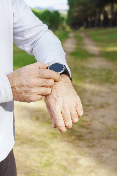 istock man training in the field with his smartwatch 1456321862