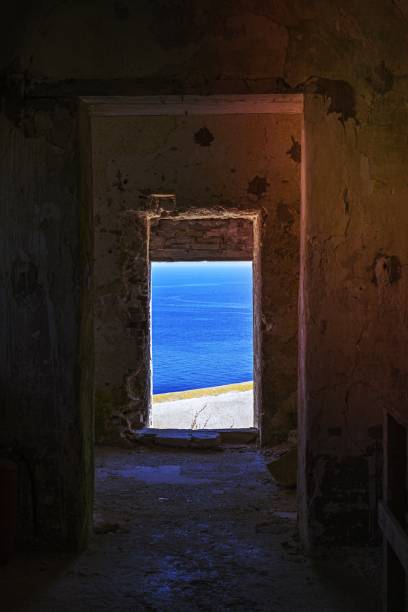istock View through old abandoned dilapidated building on the blue seascape. 1456324486