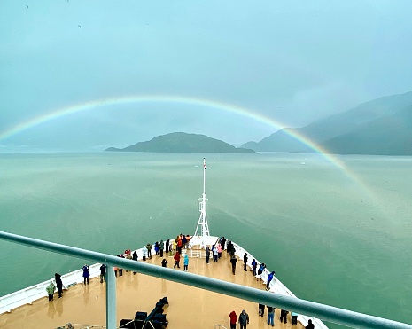 Cruiseship bow with passengers sailing toward Hubbard Glacier when rainbow appears.  1/640 F 2.4 ISO 20