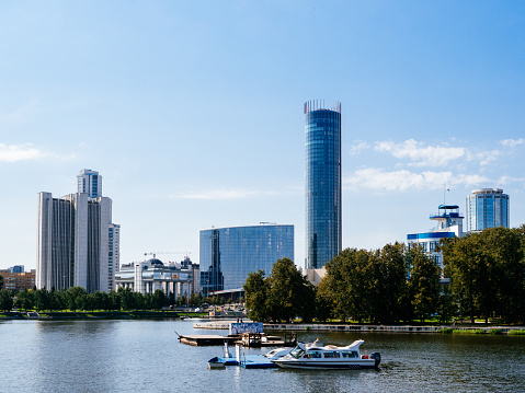 Yekaterinburg, Russia, August 27, 2020: the Hayat Hotel and the Iset tower stand on the city's embankment. Boat ride along the waterfront in the city center. Urban tourism and entertainment