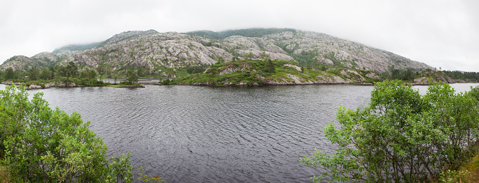 panorama Norway, Scandinavia. Beautiful landscape on the river shore middle of the stone mountains.