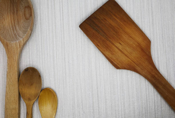 istock wooden spoon and spatula on fabric background 1456332919
