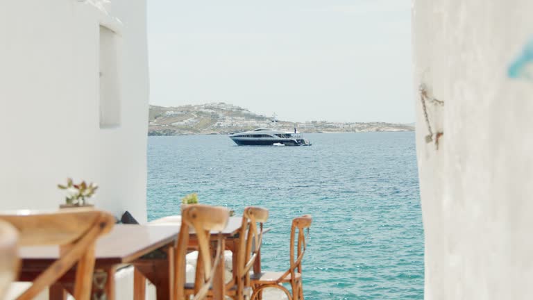 Yacht seen from an alley in Mykonos, Greece