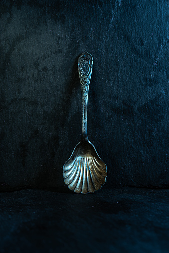 Old silver spoon. Dessert spoon made of silver. Spoon for caviar. Vertical frame.