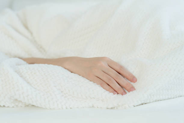 istock The woman's hand in bed 1456335951