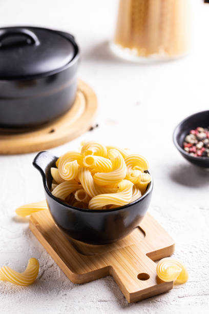 istock Cooking dinner with pasta, bowl of raw fusilli 1456338875