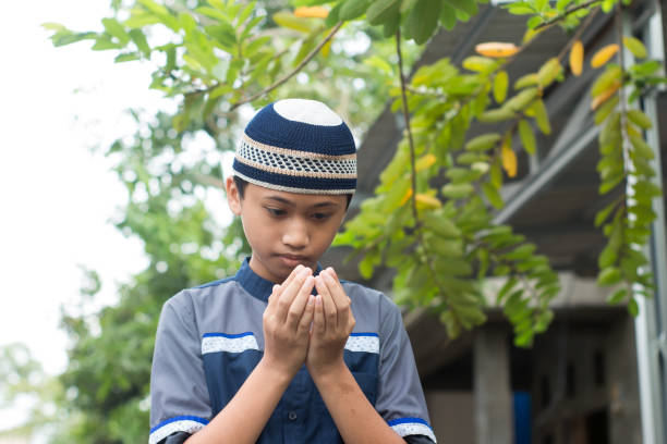 istock asian muslim boy praying to god 1456342842