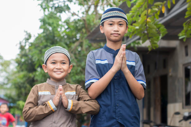 istock asian muslim boy Eid Mubarak greeting 1456343176
