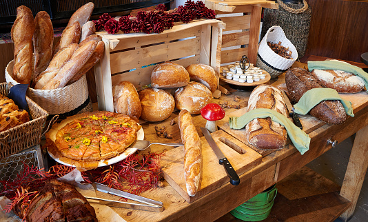 Various and Colored baked Bread buffet on Butcher board