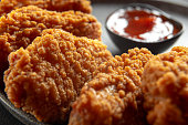 Fried chicken fillet on a dark background. Fried chicken wings as in KFC at home close-up.