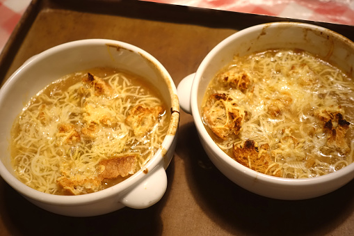 Onion soup au gratin served in bowls straight out of the oven  Traditional French cuisine